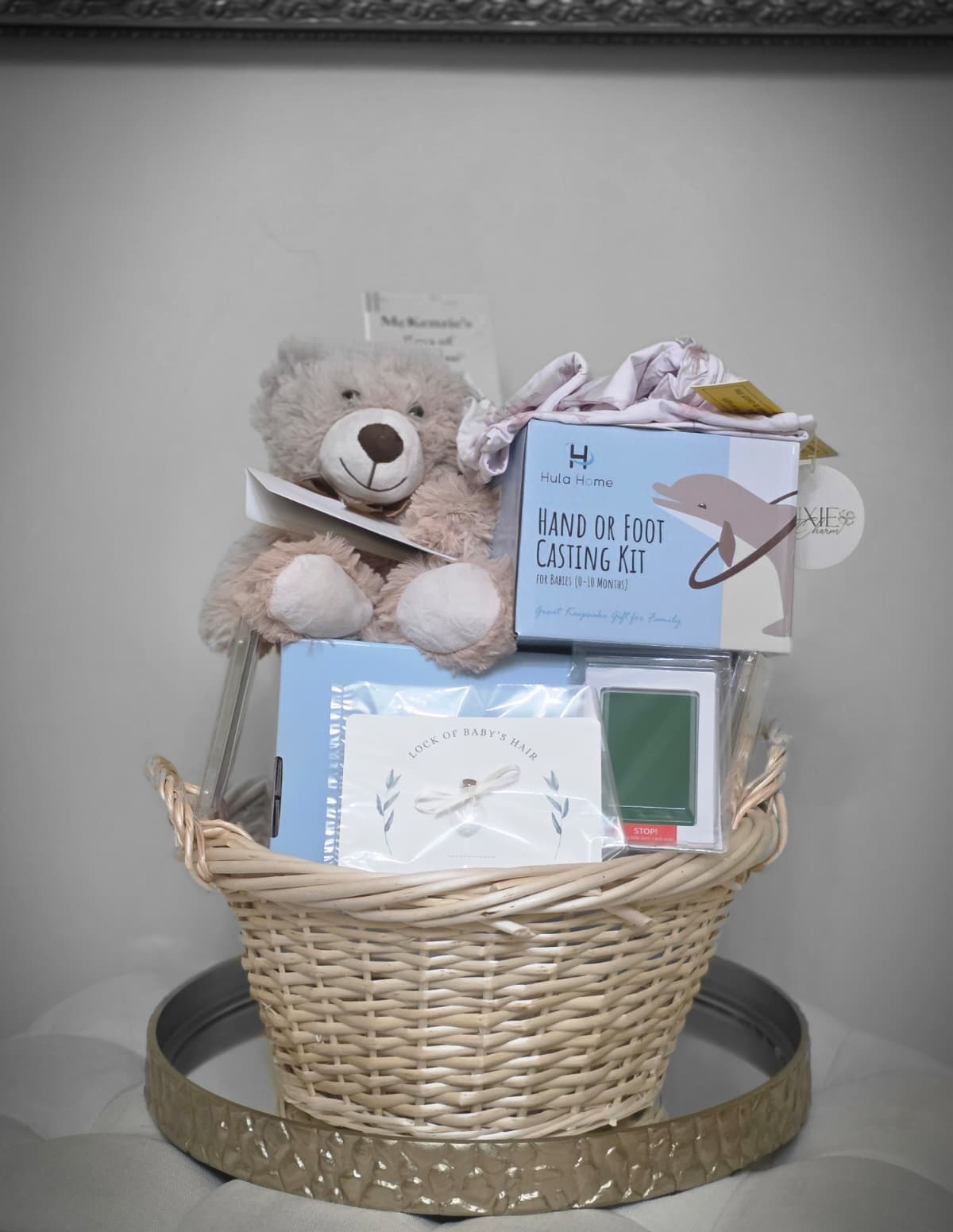 A McKenzie's Rays of Sunshine memory-making kit: keepsake basket with a comfort bear, hand and foot casting kit, and lock-of-hair keepsake